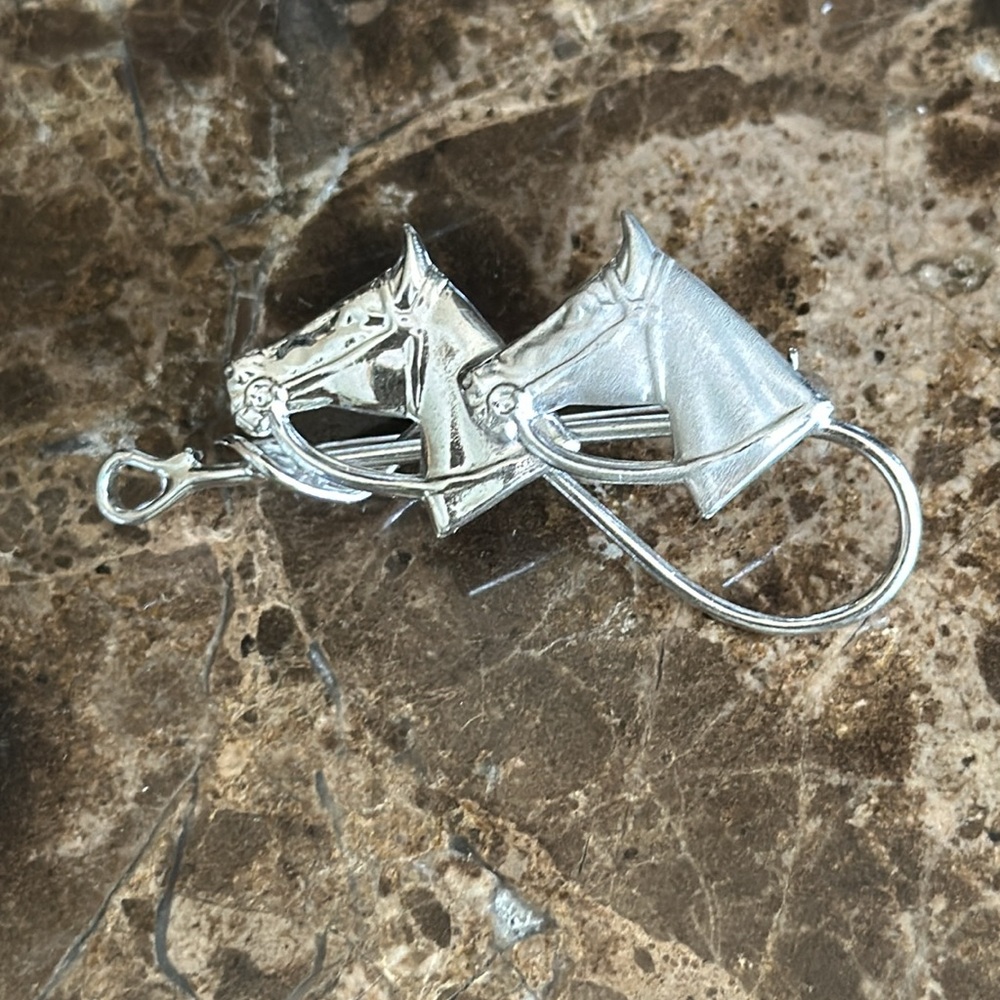Two equine heads on crop sterling silver signed on back one horse is shiny and